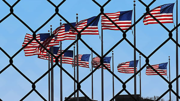 American Flags Behind Fence